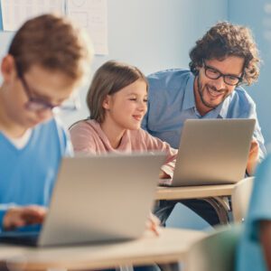 MS Girl Using Laptop Next to Teacher