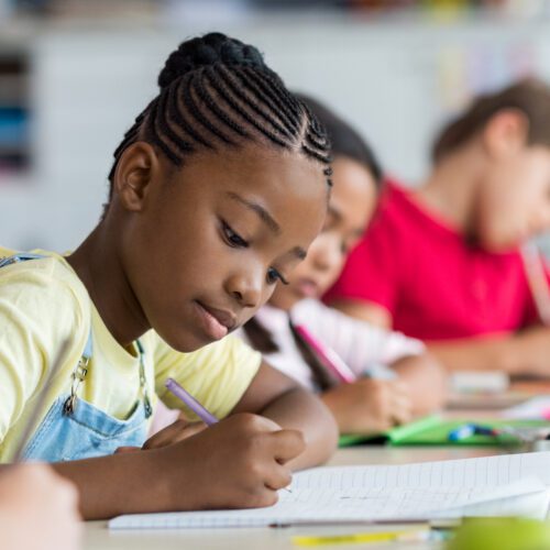 MS Girl and Classmates Working at Desk