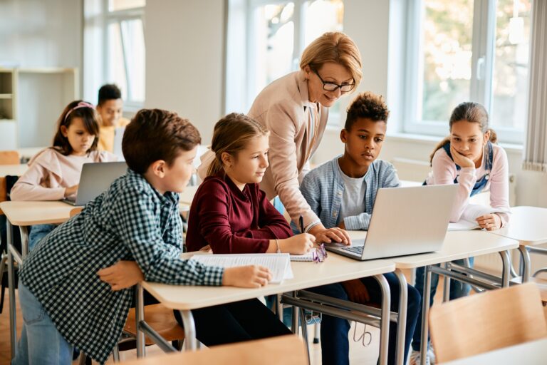 Teacher and Students Using Laptop During Class